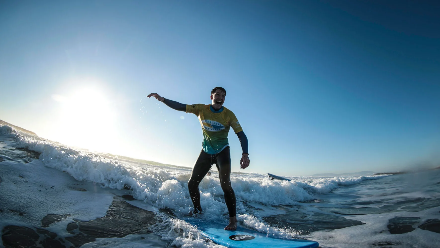 Surfista a surfar com lycra personalizada em ação na onda